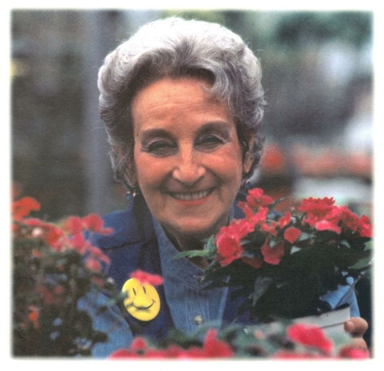 A Koolzeum hero — a white-haired woman among red flowers