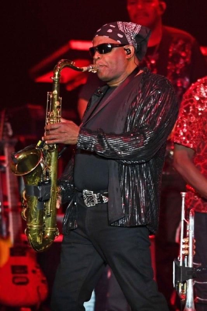 Ronald 'Khalis' Bell on tenor saxophone, in bandana, on stage